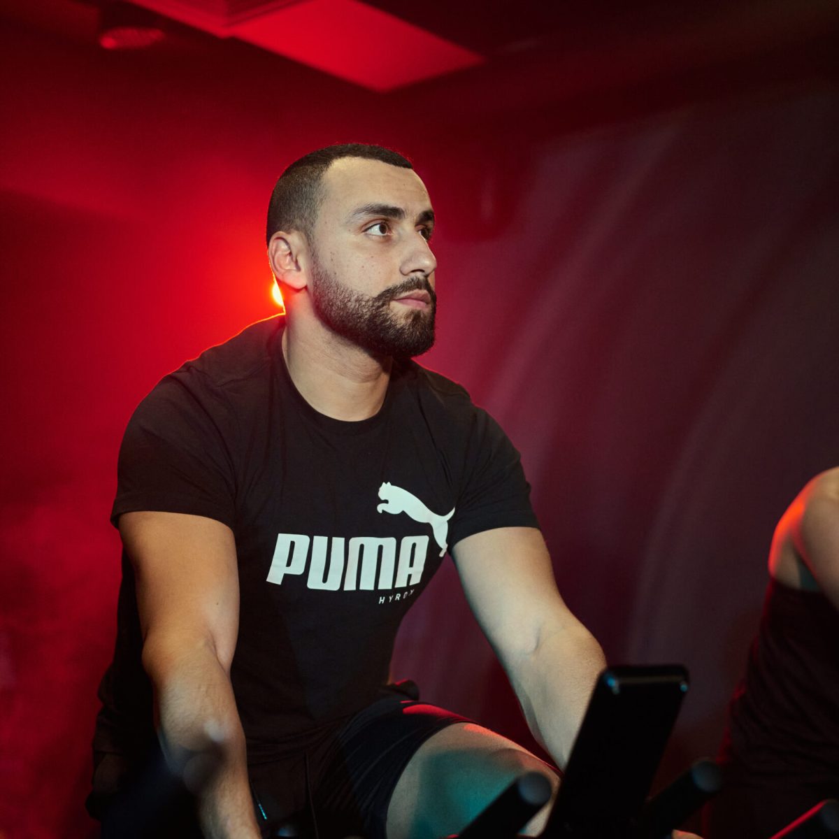 Premium indoor cycling studio at Eliteness Villeverte with immersive lighting and high-performance RPM bikes